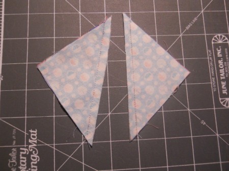 Two right triangles of fabric.
