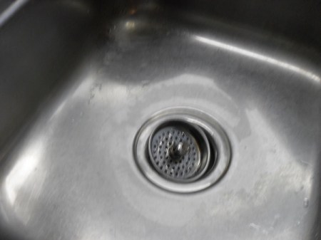 Clean sink with stopper in drain.