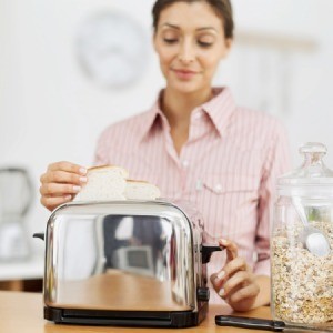 Woman Using Toaster