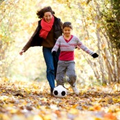 Mom Playing soccer with her Tween Daughter