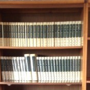 Volumes on bookshelf.