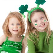 Girls in Green with shamrocks on their face.
