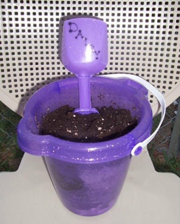 Purple planter with name on shovel.