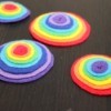 four rainbow felt pins