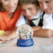 Family Looking at London Snow Globe