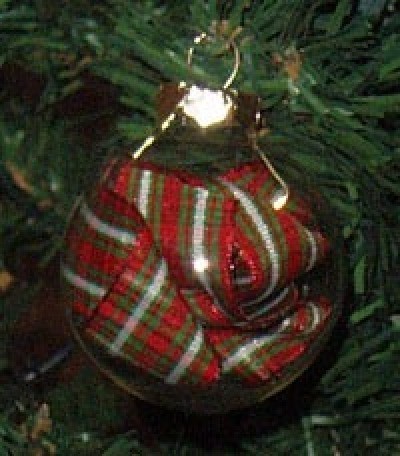 A glass ornament with ribbon inside.