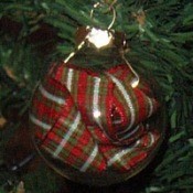 A glass ornament with ribbon inside.