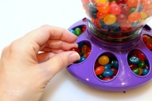 taking candy from the dispenser