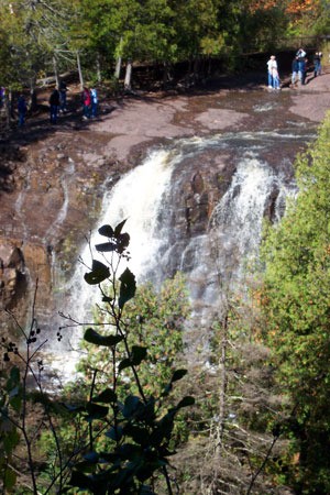 People standing at the top of a waterfall.