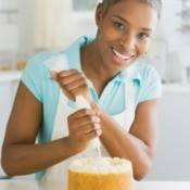 Woman Frosting a Cake