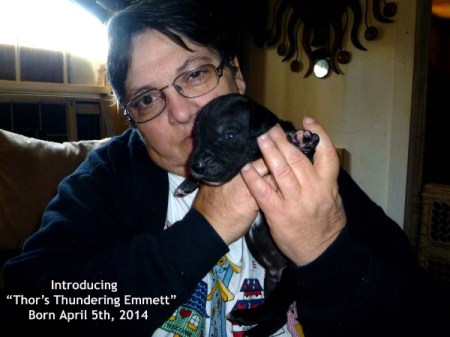 Lady holding puppy.