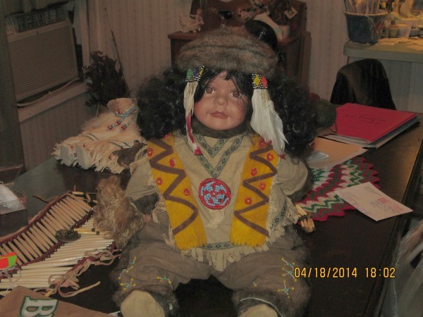 Doll with headdress and beadwork.