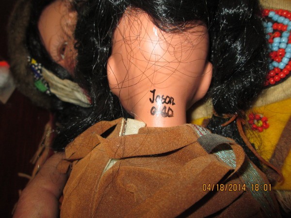 Signature on doll's neck.