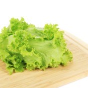 Lettuce on a cutting board.