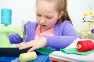 A young girl sewing.