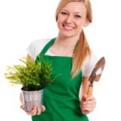 A female gardener wearing a green apron.