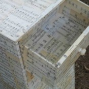 Decoupaging a dresser with old sheet music.