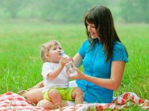 Using a plastic tablecloth as a picnic blanket.