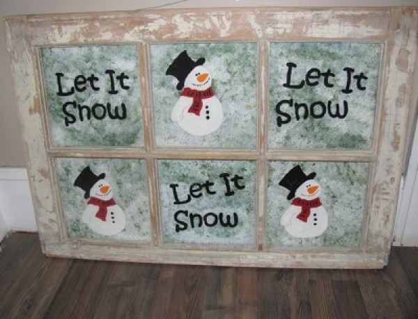 Six pane window with snowmen and lettering.