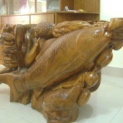 Wooden table base with fish and other details.