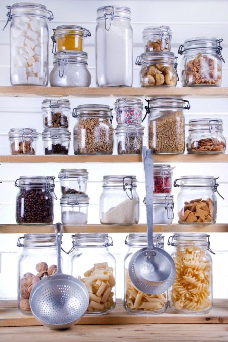 Stored food in a jars in a pantry.