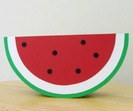 A greeting card showing a semi circular slice of watermelon.