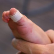 A Bandaid on a toe of a child.