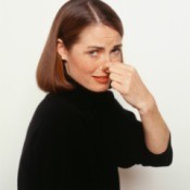 woman holding her nose