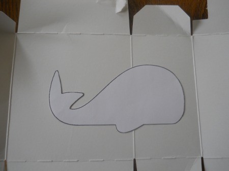 tracing whale template onto cardboard