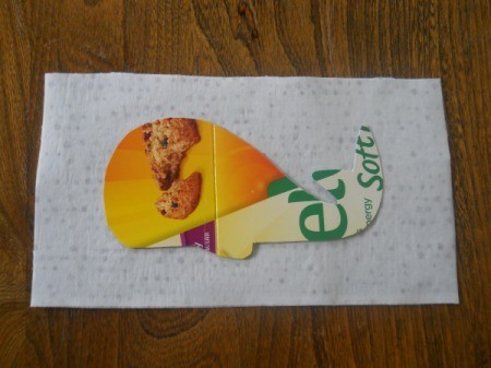 tracing whale unto paper backing of webbing using cardboard template