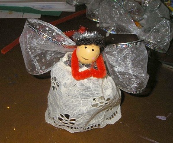 dark haired angel ornament sitting on a table