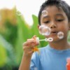 A boy blowing bubbles.