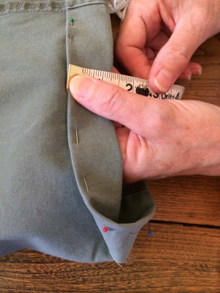 measuring and pinning up second turn of hemline