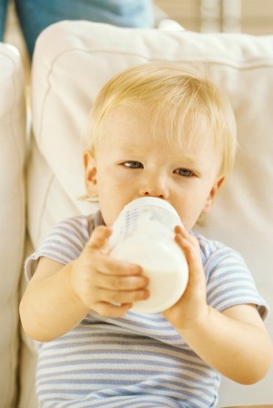 Child Drinking Milk on Couch