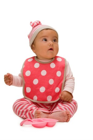 baby wearing a red and white polka dot bib