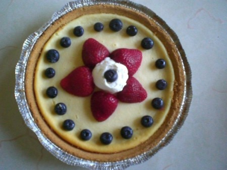 Cheesecake with strawberry star and blueberries.