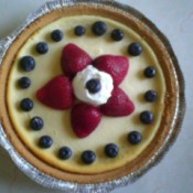 Cheesecake with strawberry star and blueberries.