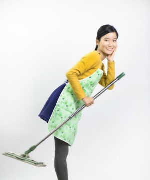 young woman holding a Swiffer style mop