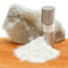 rock salt next to grinder and pile of coarsely ground salt