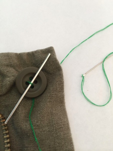 thread over spacer and through first set of holes