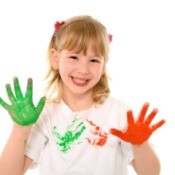 girl with paint on hands from making handprint shirt