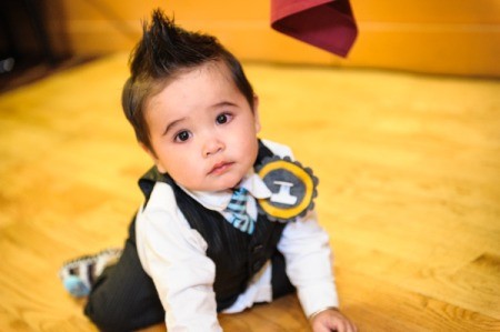 kneeling child wearing badge