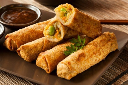 eggrolls on plate with sauce on the side