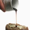 molasses being poured on slice of butter bread
