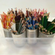 pencils separated by color in tin cans
