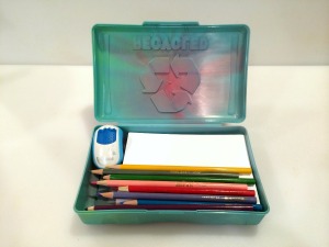green plastic box with drawing supplies