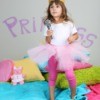 little girl dancing on bed in princess room