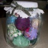 glass jar with rolled balls of fabric