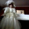 doll in fancy white dress with large hat
