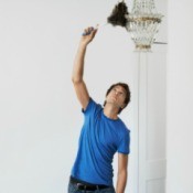 Man Cleaning a Vintage Chandelier